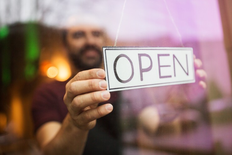 man with open banner at bar or restaurant window